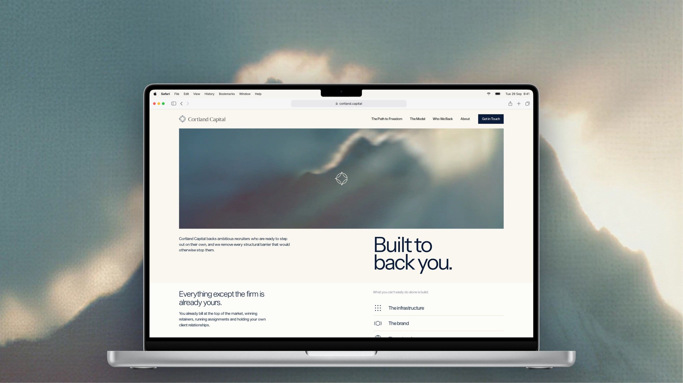 The Cortland home page, Built to back you, on a MacBook against a mountain peak