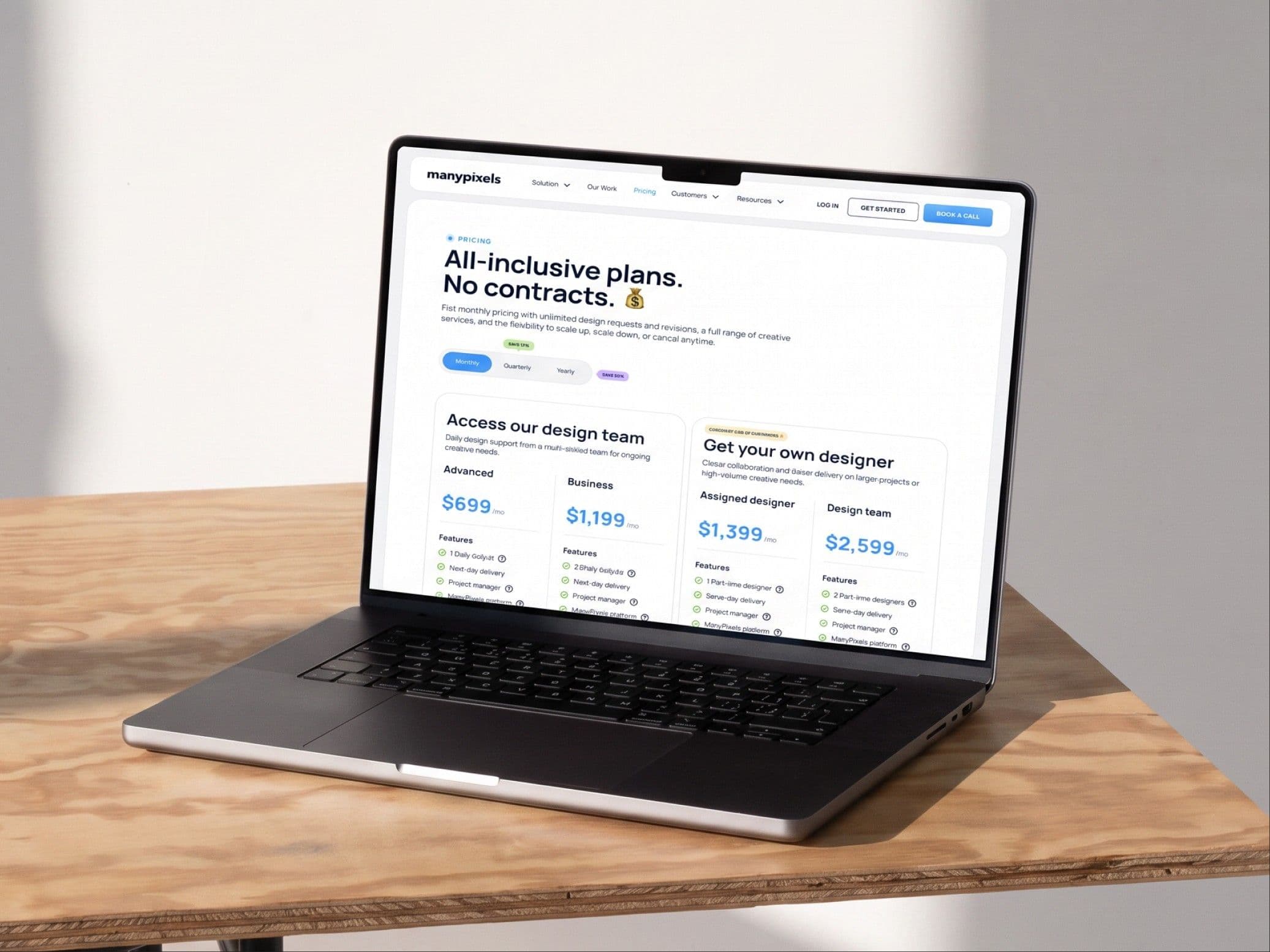 The plans page open on a laptop on a wooden desk